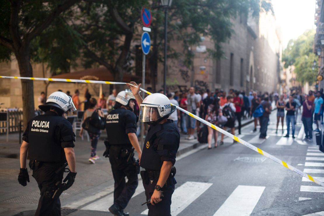 Police officers are seen near the scene of the attack. 