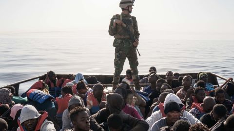 A Libyan coast guardsman stands on a boat during the rescue of 147 migrants attempting to reach Europe in June.  