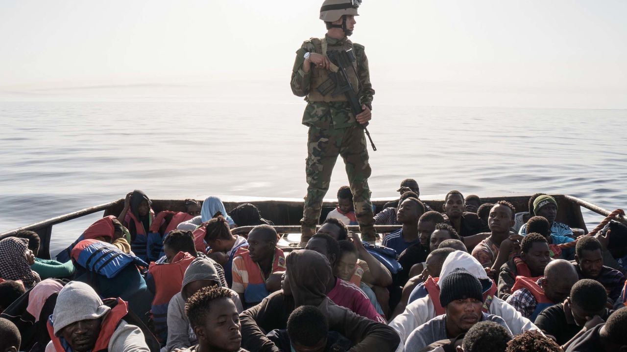 A Libyan coast guardsman stands on a boat during the rescue of 147 people attempting to reach Europe in June 2017.