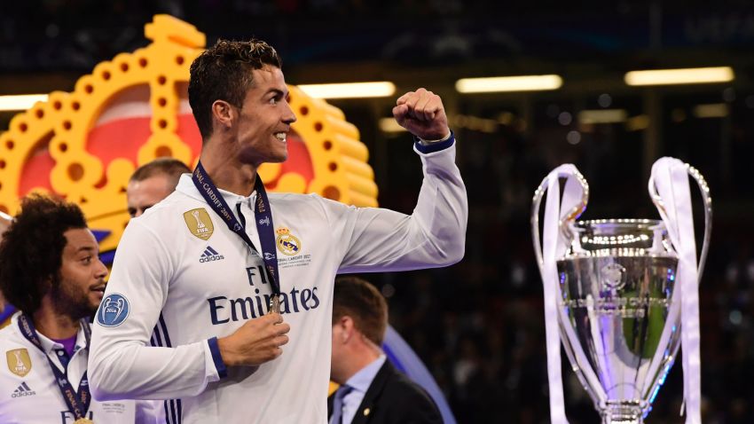 Real Madrid's Portuguese striker Cristiano Ronaldo celebrates next to the trophy after Real Madrid won the UEFA Champions League final football match between Juventus and Real Madrid at The Principality Stadium in Cardiff, south Wales, on June 3, 2017. / AFP PHOTO / JAVIER SORIANO (Photo credit should read JAVIER SORIANO/AFP/Getty Images)