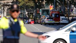 A policemen stand as he blocks the street to a cordoned off area after a van ploughed into the crowd, injuring several persons on the Rambla in Barcelona on August 17, 2017. / AFP PHOTO / PAU BARRENA        (Photo credit should read PAU BARRENA/AFP/Getty Images)