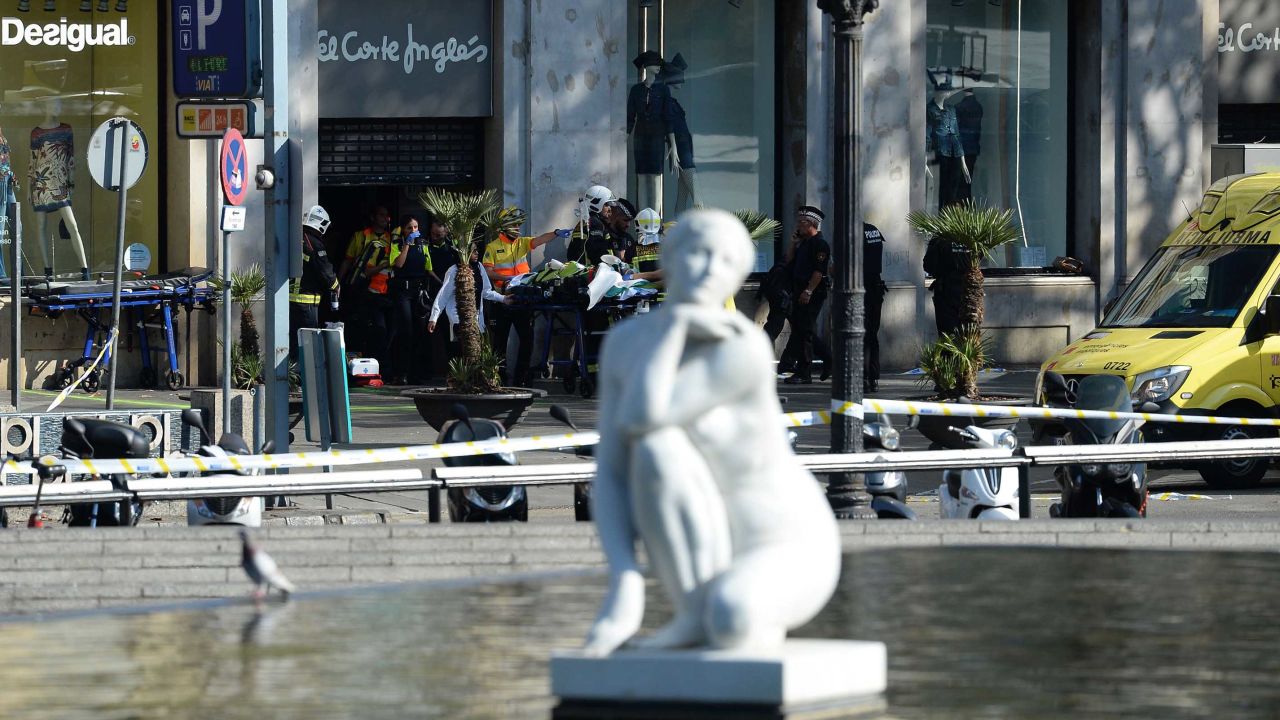 A person is stretched out of a mall by medical staff members in a cordoned off area after a van ploughed into the crowd, injuring several persons on the Rambla in Barcelona on August 17, 2017.
Police in Barcelona said they were dealing with a "terrorist attack" after a vehicle ploughed into a crowd of pedestrians on the city's famous Las Ramblas boulevard on August 17, 2017. Police were clearing the area after the incident, which has left a number of people injured. / AFP PHOTO / Josep LAGO        (Photo credit should read JOSEP LAGO/AFP/Getty Images)