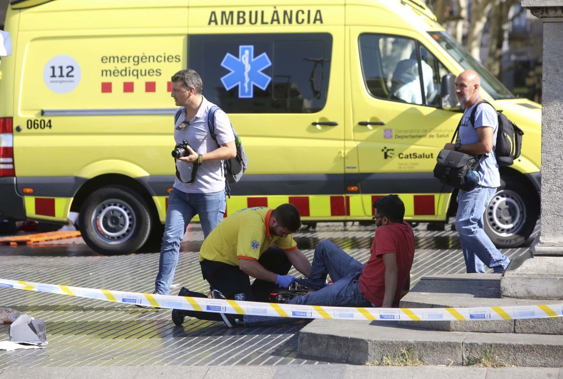 An injured person is treated Thursday after a van jumped the sidewalk in Barcelona's Las Ramblas area. 