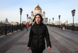 Tolokonnikova walks to her first public news conference following her release from prison with the Christ the Saviour Cathedral in the background.