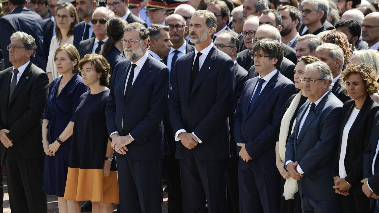 Spain's King Felipe VI joins other officials in observing a minute of silence in Barcelona's Plaça de Catalunya.