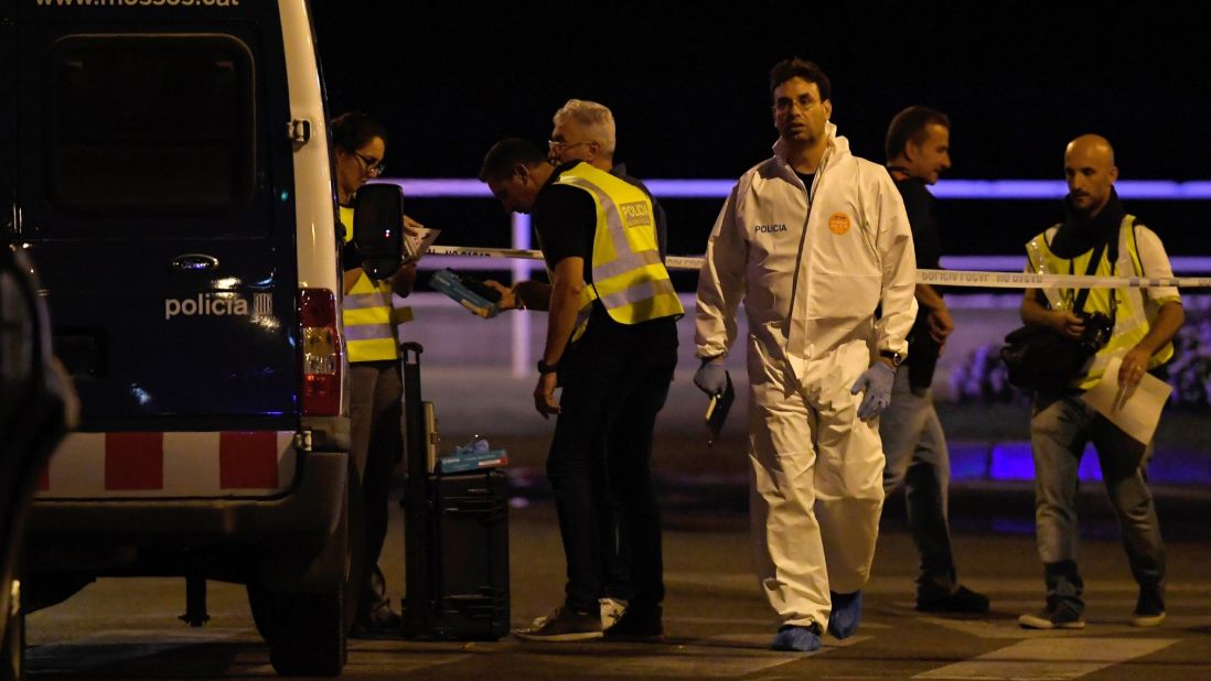 Police officers work at the scene in Cambrils.