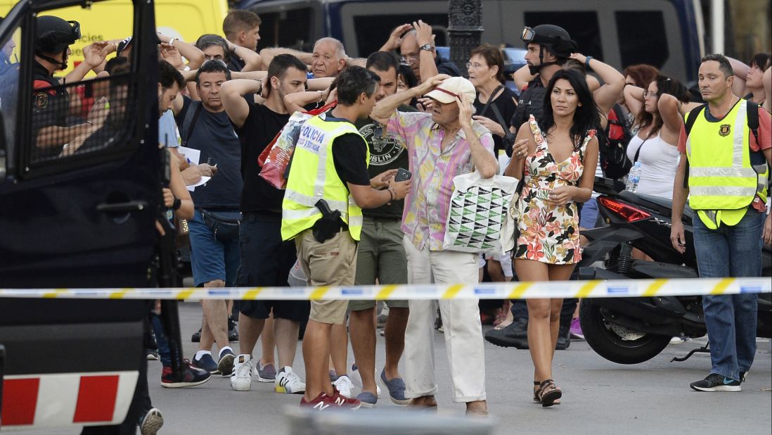 Police check people's identities as they clear Las Ramblas on August 17.