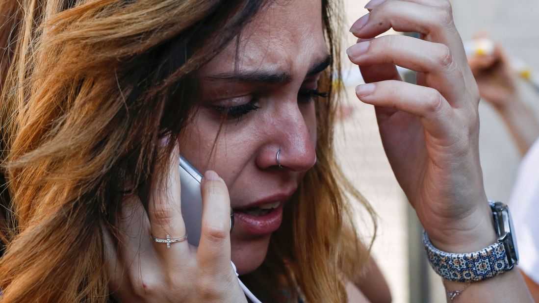 A woman cries as she speaks on her phone in Barcelona on August 17.