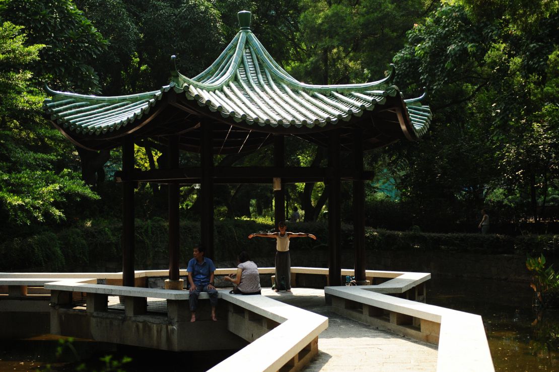 A man practices Tai Chi in Kowloon Park. 