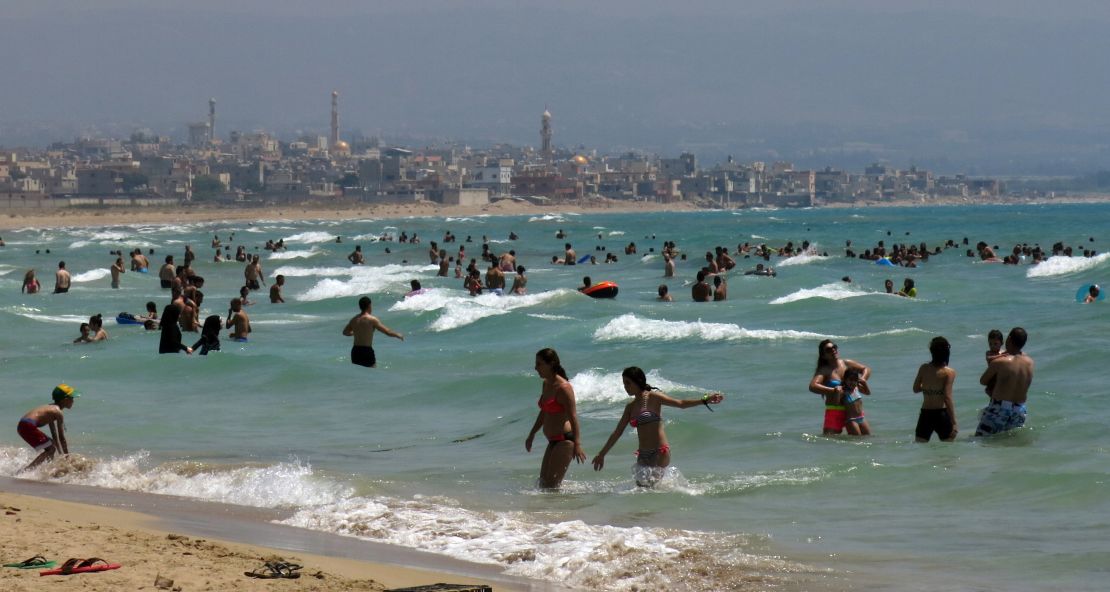 Beach goers crowd a public beach in the southern Lebanese coastal city of Tyre.