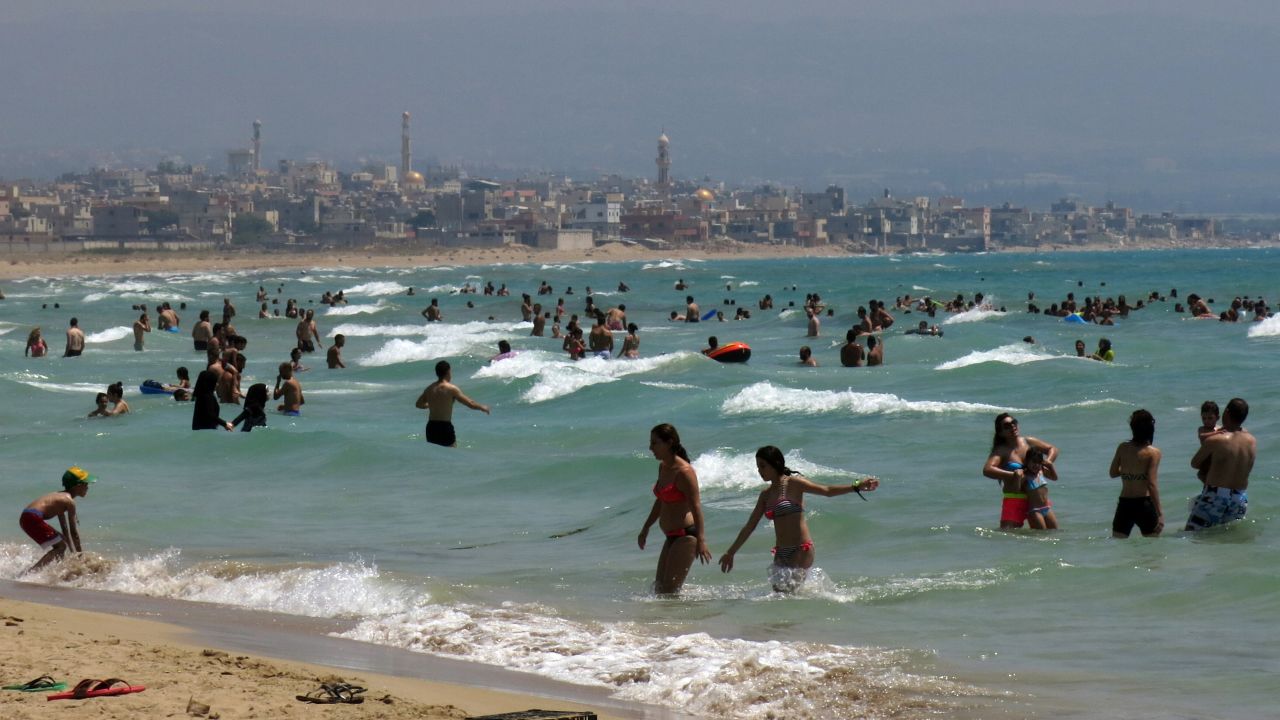 Beach goers crowd a public beach in the southern Lebanese coastal city of Tyre.