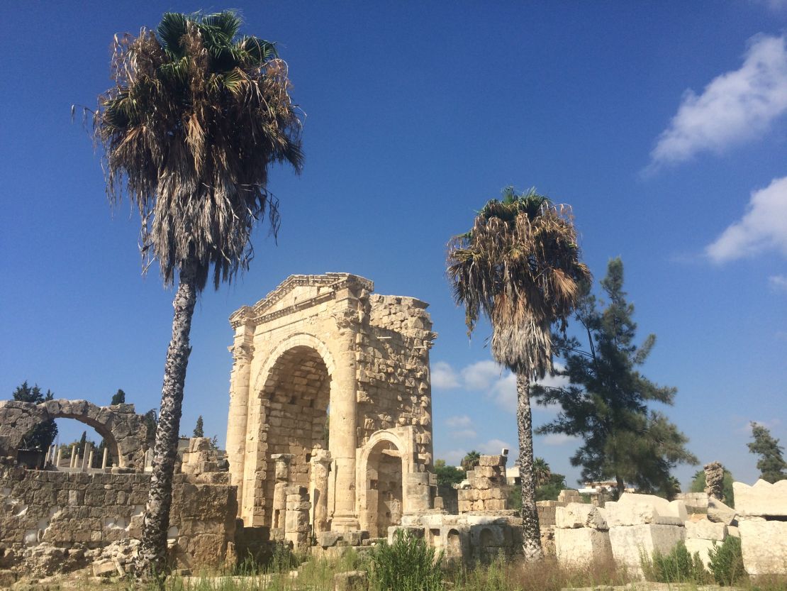 The Triumphal Arch and palm trees at the Al Bass site in Tyre, Lebanon.