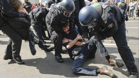 Police detain a counterprotester Saturday during the right-wing march in Berlin.