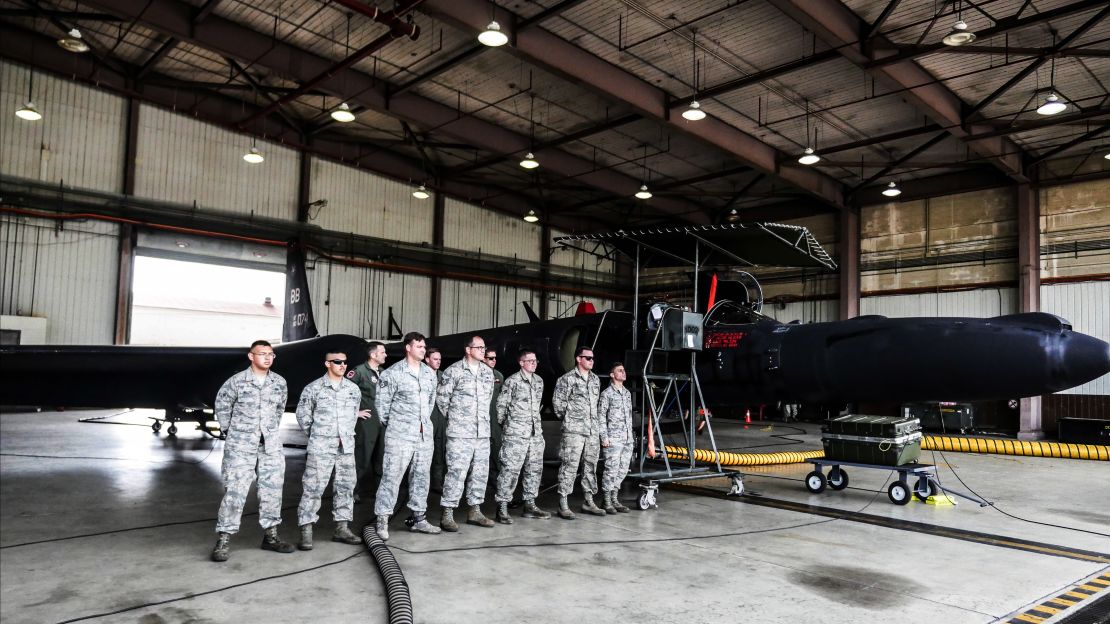 US Air Force crew stand in front of a U-2 spy plane at Osan Air Base, South Korea.