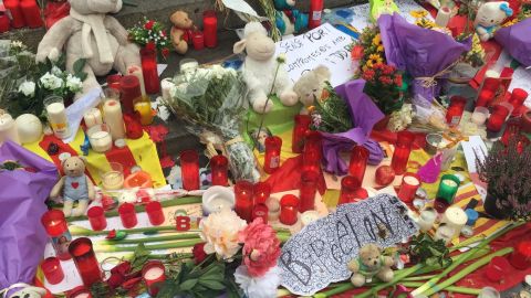 Candles, flowers, toys and messages of solidarity are left at a makeshift memorial on Las Ramblas.