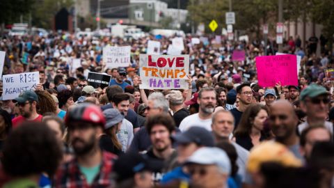 Counterprotesters hold signs as they prepare to march against the self-described free-speech rally.