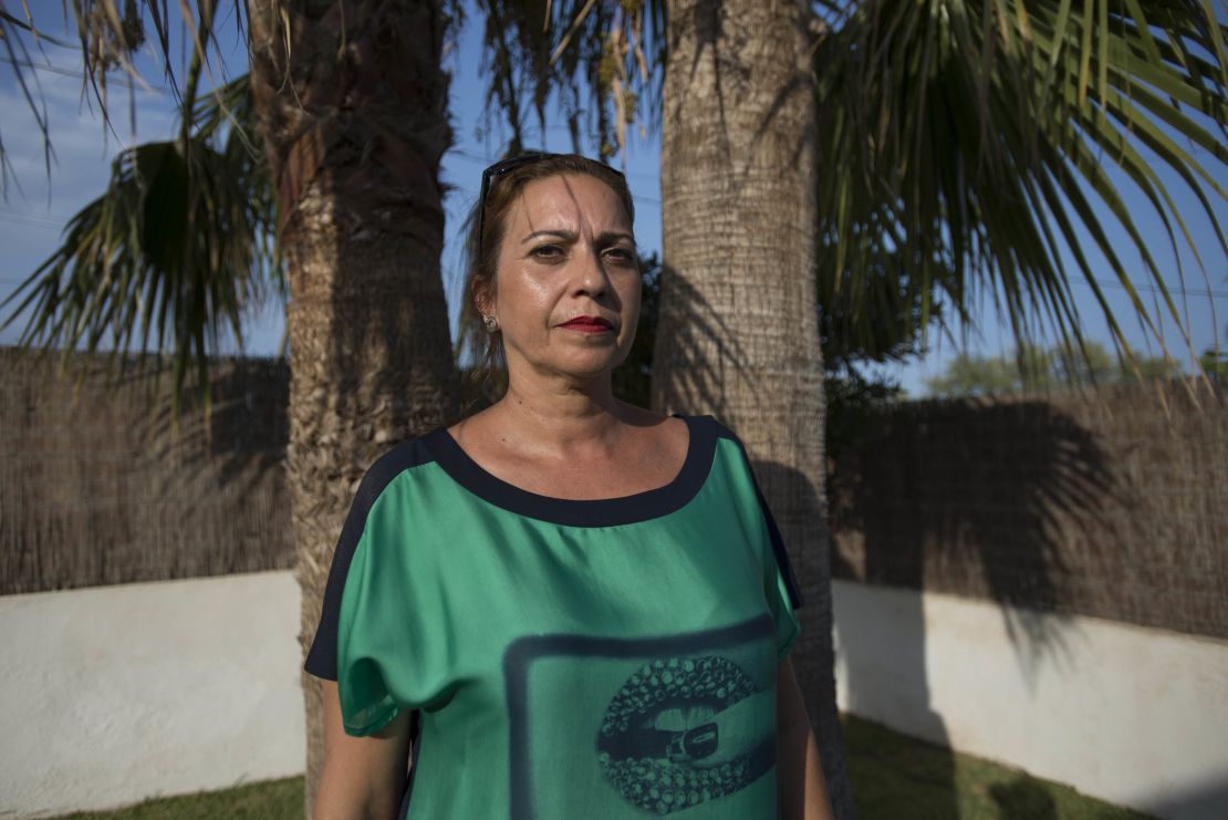 Gil, standing under a palm tree in her front yard, says she can't imagine why the suspects chose her neighborhood as their home base.