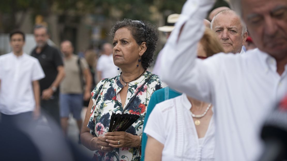 Meera Andrews, center, waits in line to attend the memorial mass at Sagrada Familia cathedral on Sunday, August 20.