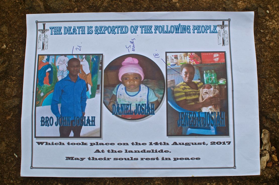 Gabriel Fattah Manga holds a poster showing the family members he lost in the mudslide that hit Sierra Leone's capital, Freetown.