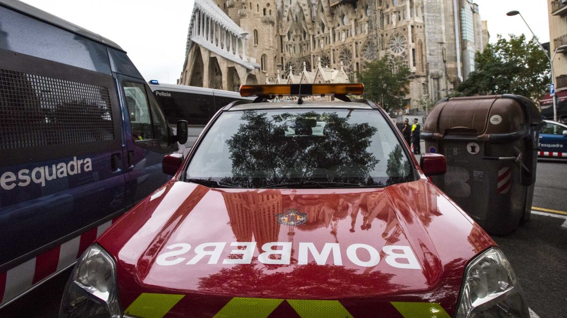 Police and fire vehicles parked outside the cathedral.