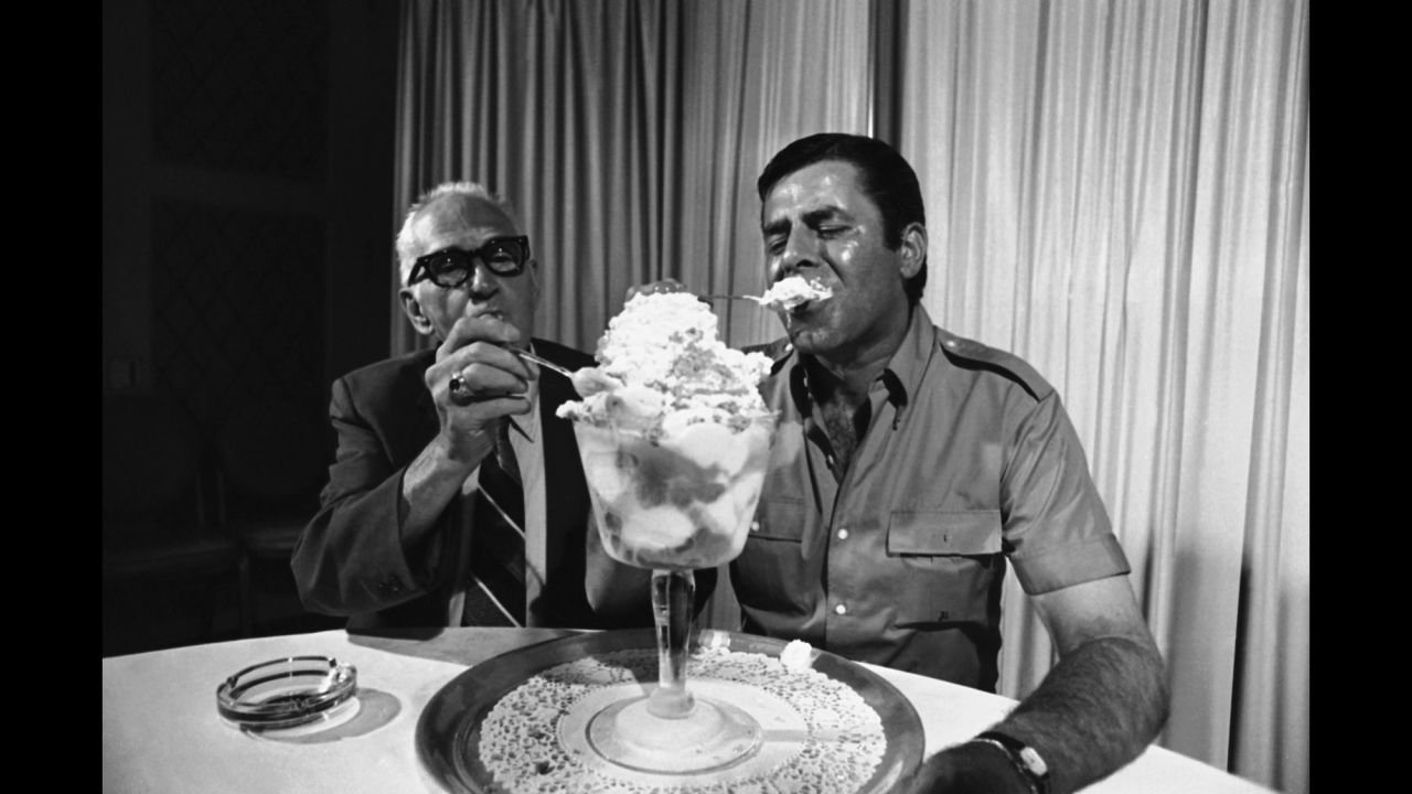 Lewis tries out a Jerry Lewis special in 1971. The ice cream special was offered by a Troy, New York, pharmacy where Lewis worked as a young man. Lewis' former boss, Ben Silberg, helps eat the giant sundae.