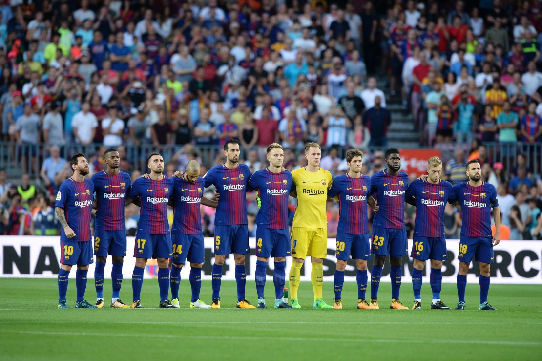 Barcelona players observe a minute's silence ahead of the Spanish league game against Real Betis.