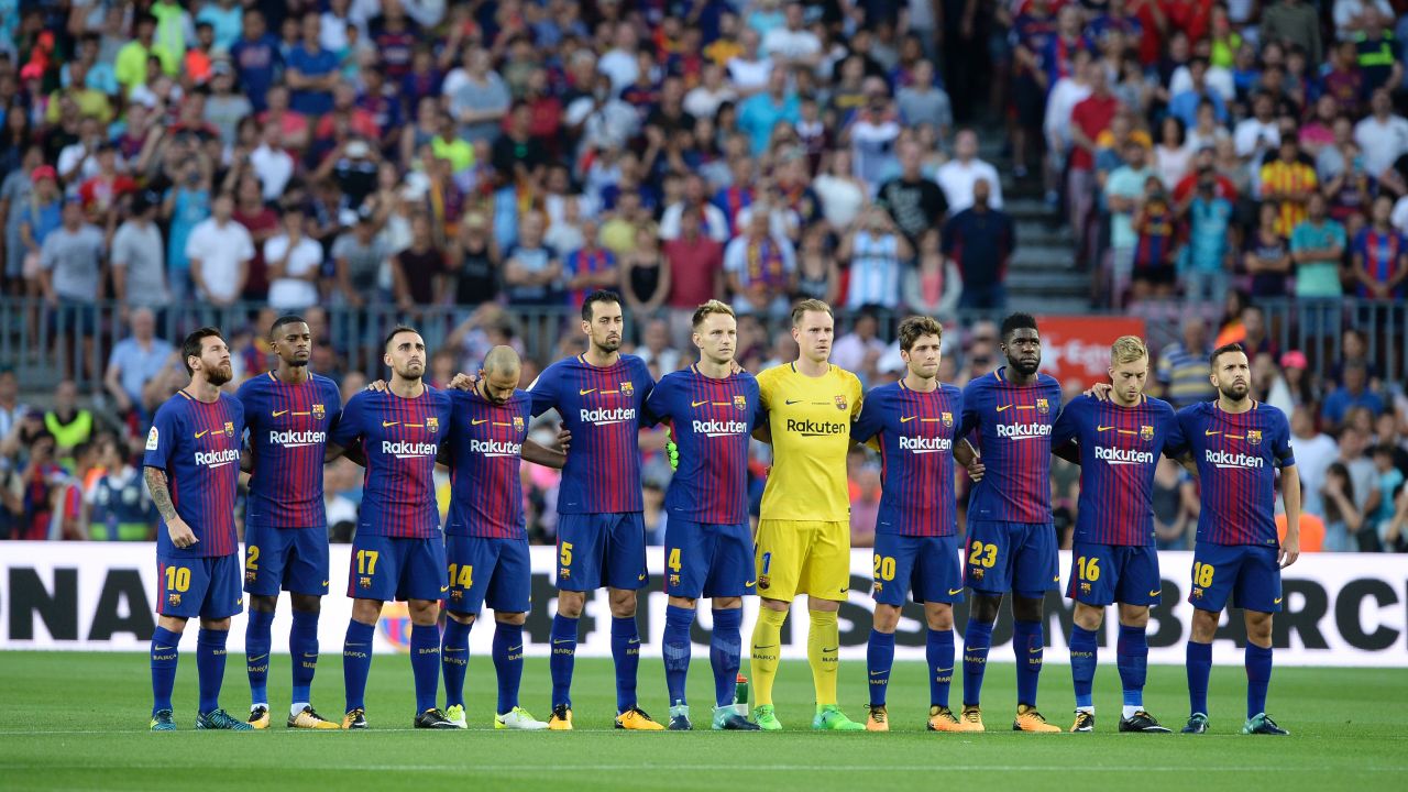 Barcelona players observe a minute's silence ahead of the Spanish league game against Real Betis.