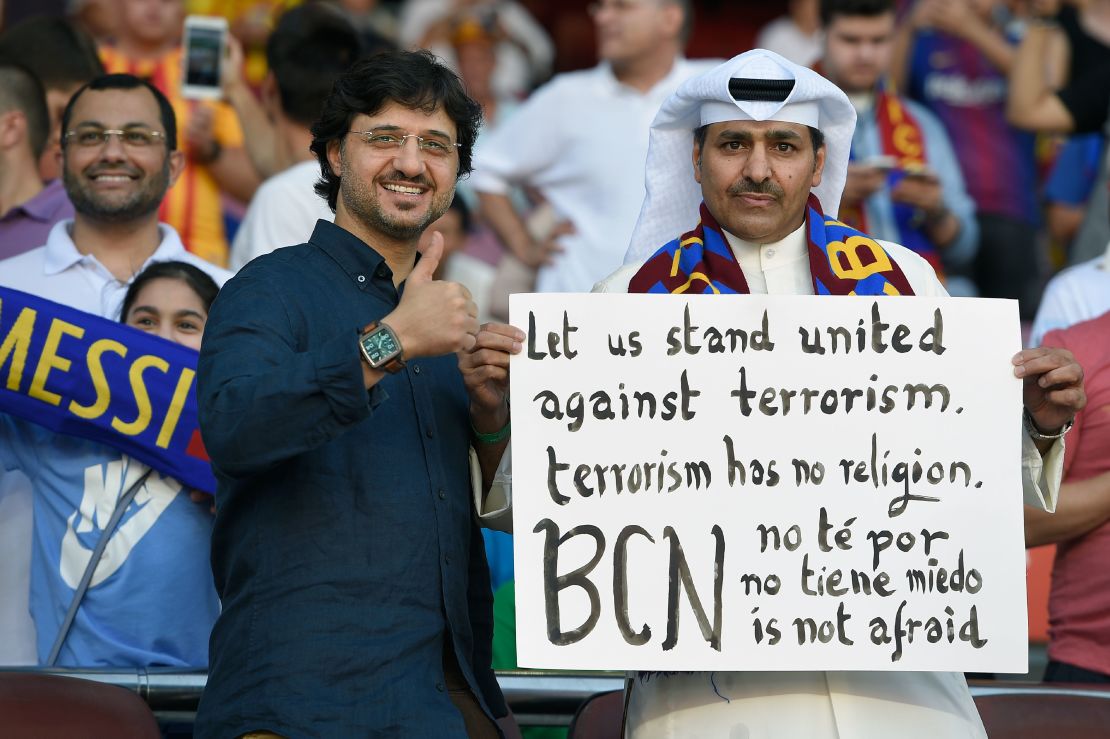 A Barcelona fan holds a placard against terrorism at the game against Betis.