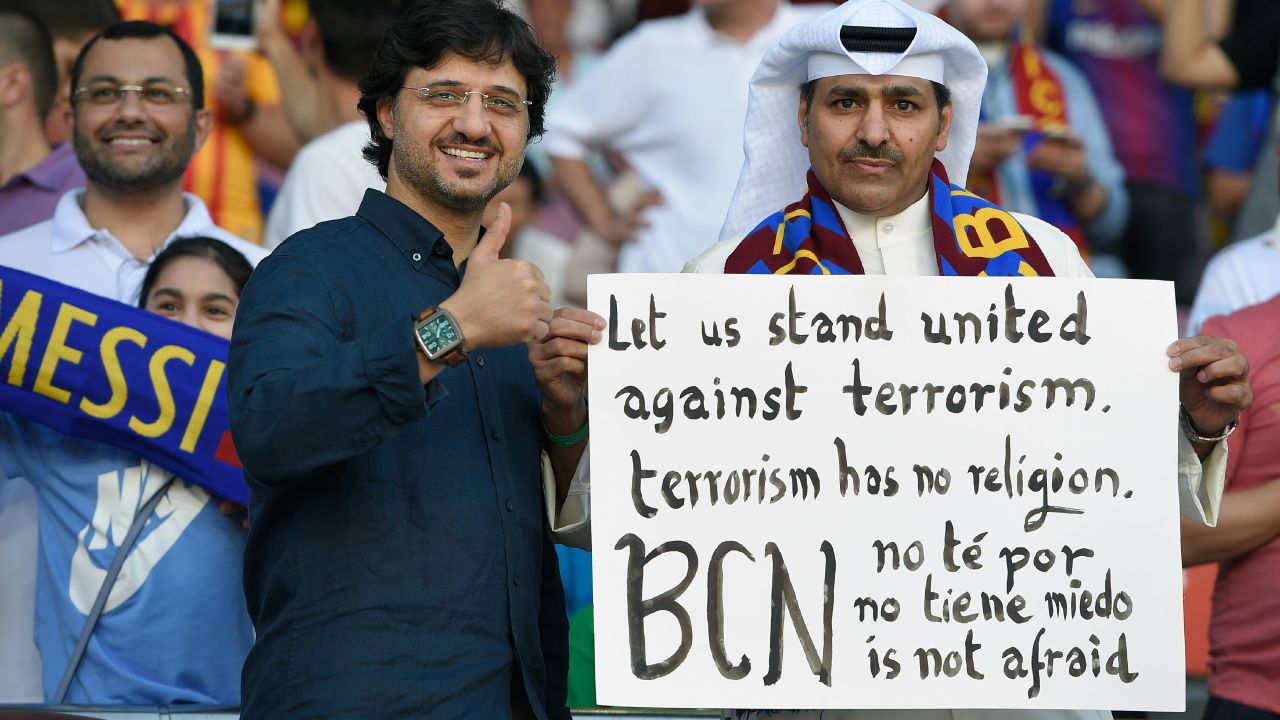 A Barcelona fan holds a placard against terrorism at the game against Betis.