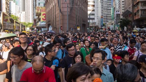 Thousands of protestors march through Wanchai district in support of the three men, who were jailed last week after being convicted of unlawful assembly.