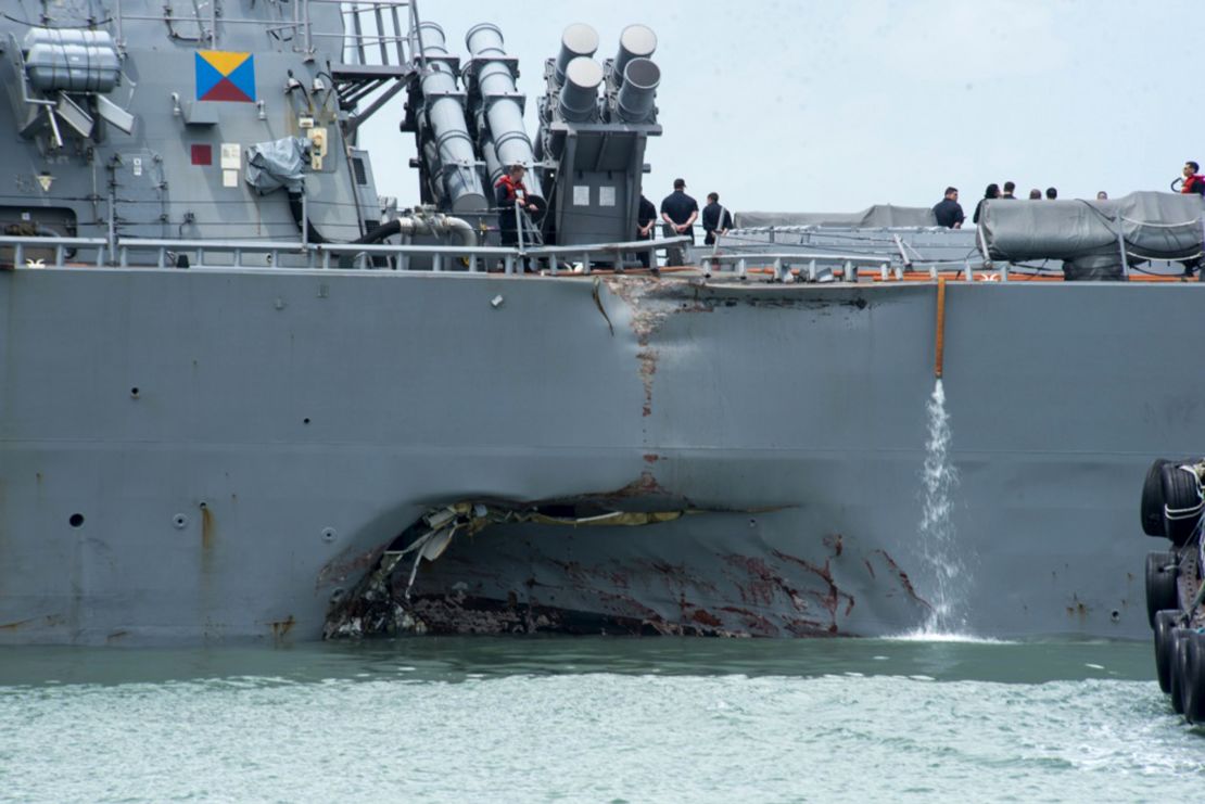 Destroyer USS John S. McCain shows damage to its port side following a collision with a merchant vessel on  August 21.