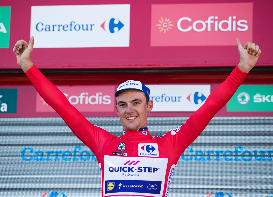 Belgium cyclist Yves Lampaert celebrates on the podium after winning La Vuelta's second stage.