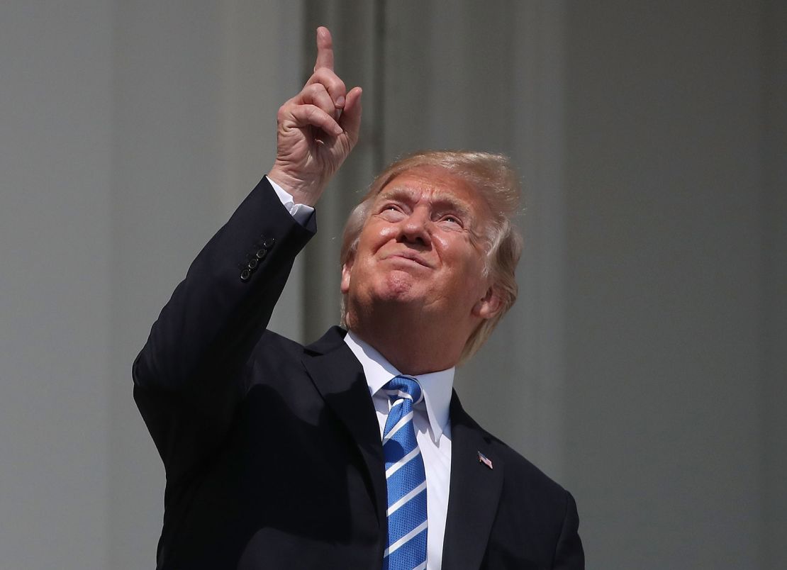 President Donald Trump looks up toward the Solar Eclipse on the Truman Balcony at the White House on August 21, 2017.