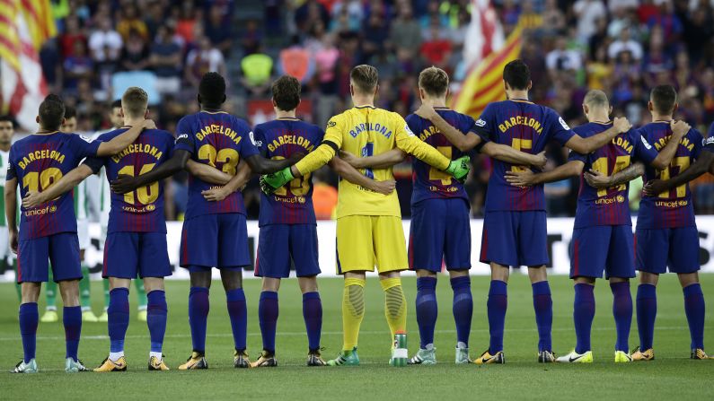 Barcelona players -- wearing their city on their jerseys instead of their names -- observe a minute of silence before a Spanish league match against Real Betis on Sunday, August 20. Three days earlier, <a href="index.php?page=&url=http%3A%2F%2Fwww.cnn.com%2F2017%2F08%2F17%2Feurope%2Fgallery%2Fbarcelona-van-attack%2Findex.html" target="_blank">a van rammed into a crowd of people</a> in Barcelona, killing 13 and injuring more than 100. 