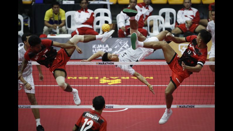 Thailand's Pornchai Kaokaew, center, kicks a ball during a sepak takraw match against Indonesia on Friday, August 18.