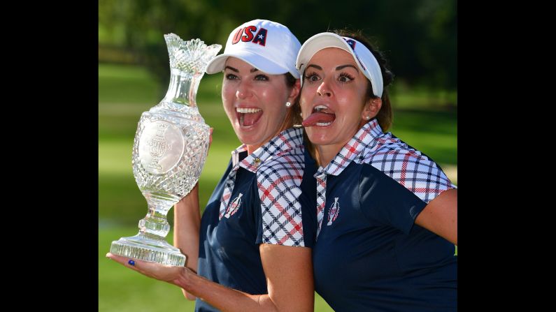 Paula Creamer, left, and Gerina Piller pose with the Solheim Cup trophy after Team USA defeated Europe on Sunday, August 20.