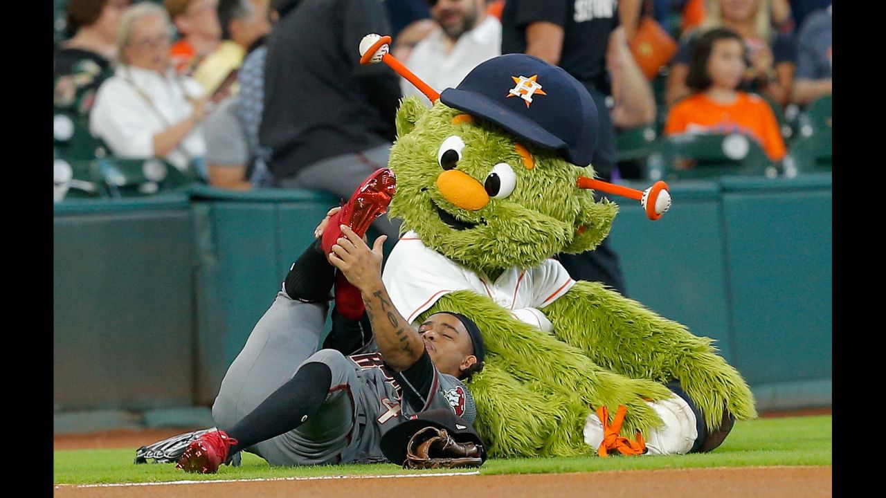 Ketel Marte stretches with the Houston Astros' mascot, Orbit, before a game on Thursday, August 17.