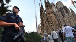 TOPSHOT - A police officer stands by the Sagrada Familia basilica in Barcelona on August 20, 2017, before a mass to commemorate victims of two devastating terror attacks in Barcelona and Cambrils.
A grief-stricken Barcelona prepared today to commemorate victims of two devastating terror attacks at a mass in the city's Sagrada Familia church. As investigators scrambled to piece together the attacks which killed 14 people in all, Interior Minister Juan Ignacio Zoido said on August 19 the cell behind the carnage that also injured 120 and plunged the country into shock had been "dismantled," though local authorities took a more cautious tone.

 / AFP PHOTO / PASCAL GUYOT        (Photo credit should read PASCAL GUYOT/AFP/Getty Images)