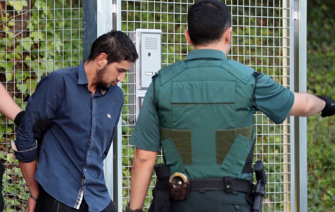 Salah el Karib, one of four suspects arrested in the  attacks, is escorted into court Tuesday in Madrid.