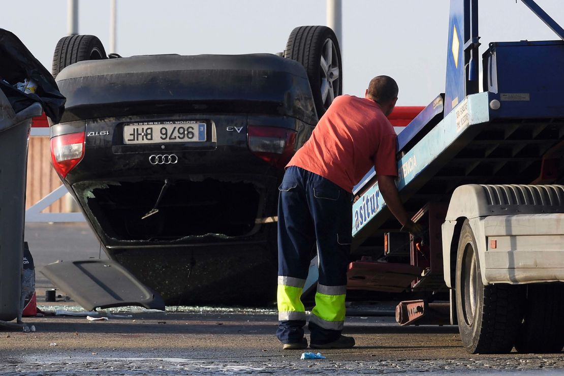 An employee starts to tow away a car involved in a terrorist attack in Cambrils, south of Barcelona.