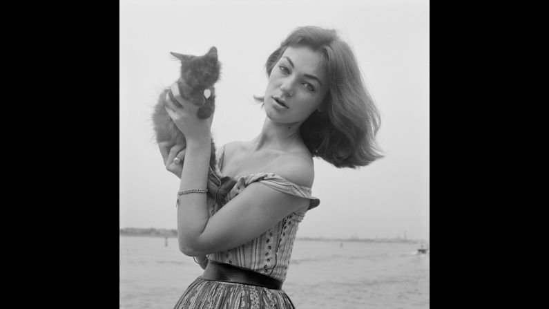 Promoting the 1955 Italian horror film "Gli Sbandati" (The Abandoned), American actress and model Ivy Nicholson shows off her feline friend to photographers.