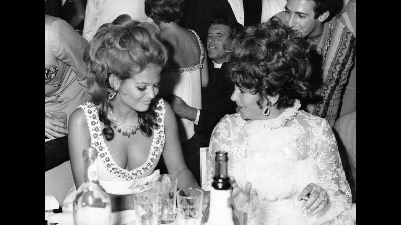 Elizabeth Taylor and Claudia Cardinale at a charity ball held in Venice during the festival.