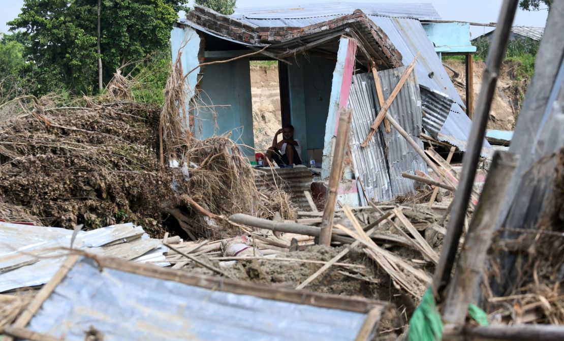 A man rests in his house damaged by flooding some 250 kilometers from Nepal's capital Kathmandu on August 16.