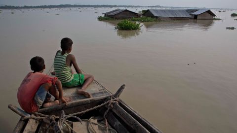 In this Aug. 15, 2017, photo, flood affected villagers travel by boat in floodwaters in Morigaon district, east of Gauhati, northeastern state of Assam.