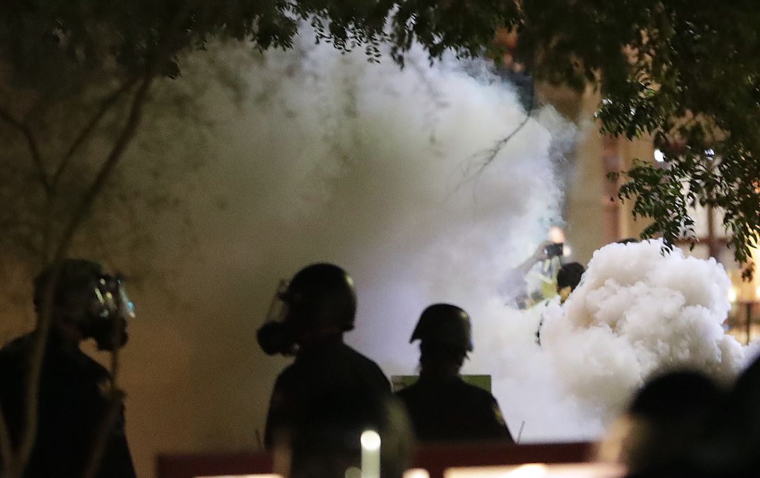 Smoke billows after Phoenix police used tear gas outside the convention center where President Trump hosted a rally Tuesday night.