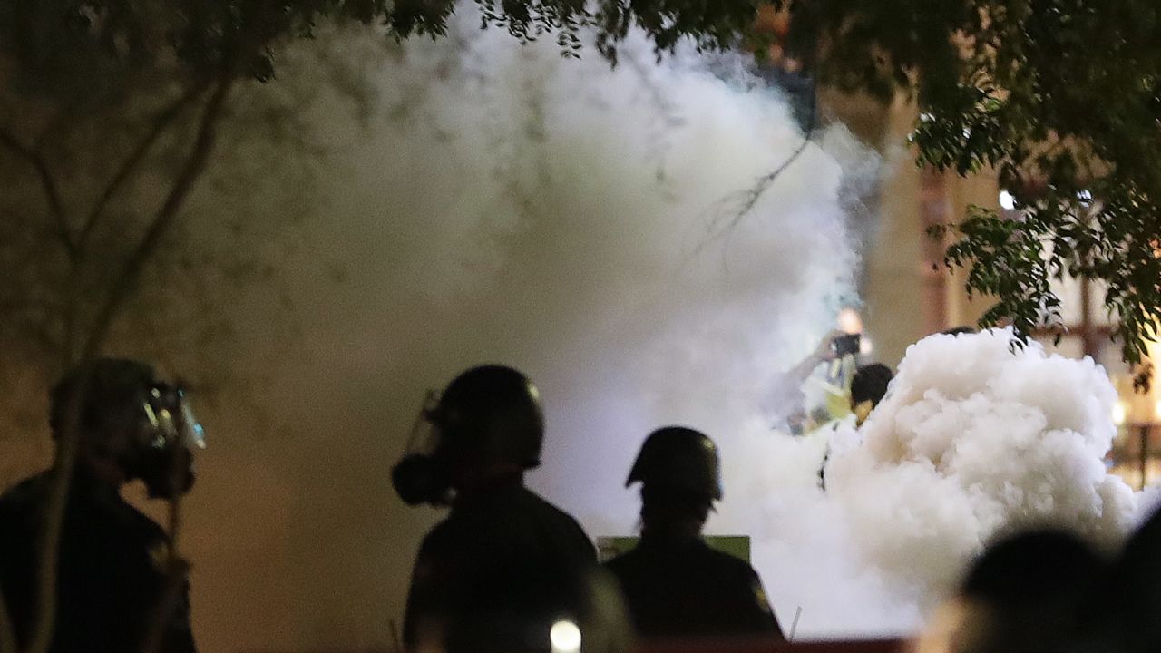 Smoke billows after Phoenix police used tear gas outside the Phoenix Convention Center, Tuesday, Aug. 22, 2017, in Phoenix. Protests were held against President Donald Trump as he hosted a rally inside the convention center. (AP Photo/Matt York)