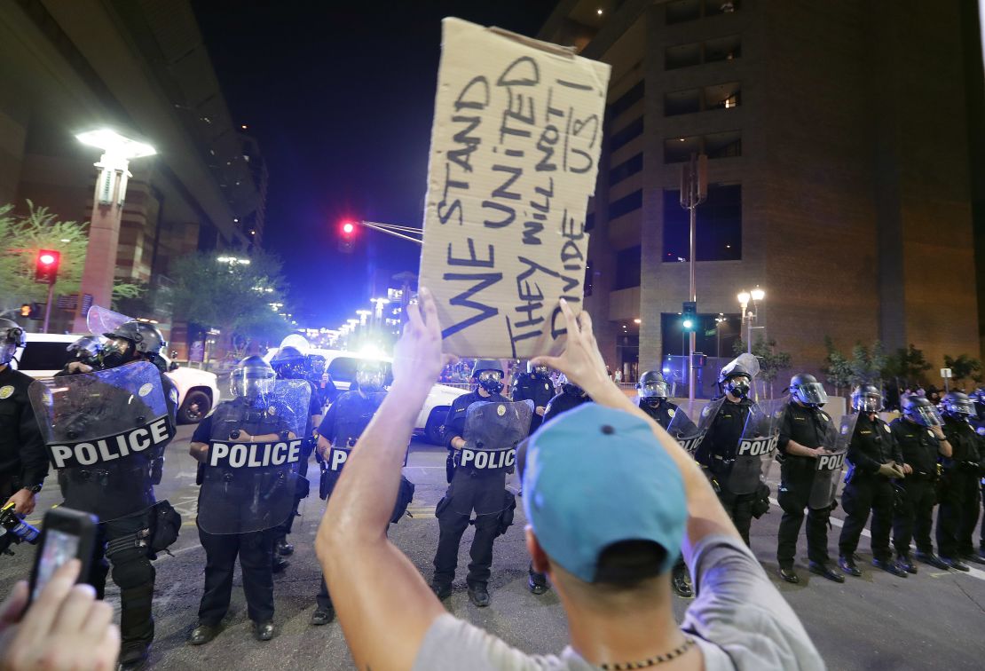 Protesters yell after Phoenix police used tear gas outside the convention center Tuesday night.