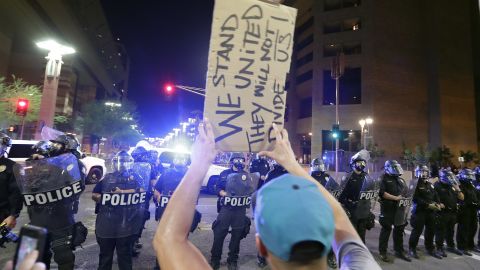Protesters yell after Phoenix police used tear gas outside the convention center Tuesday night.