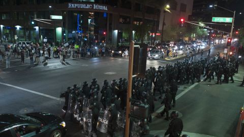 Riot police form a line outside the convention center.