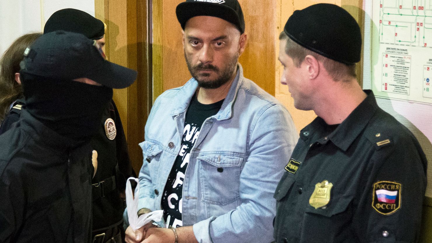 Russian theater and film director Kirill Serebrennikov is ushered into court for a hearing on August 23, 2017, in Moscow.